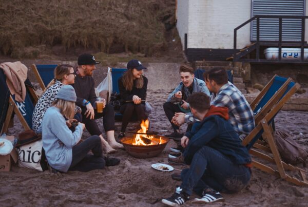 group of people sitting on front firepit